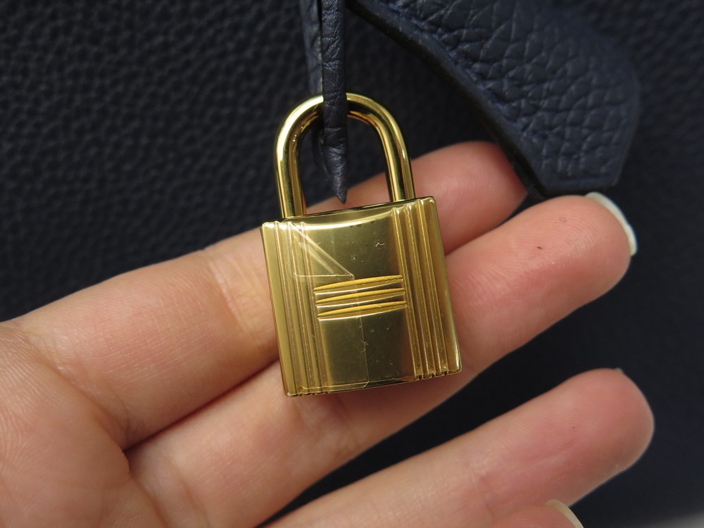 HERMÈS, petit cadenas de sac doré avec deux clés N°101. …